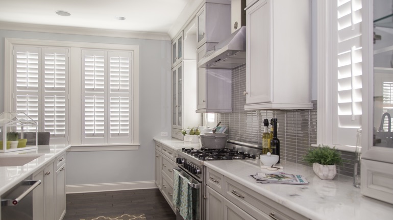 Plantation shutters in Fort Lauderdale kitchen with modern appliances.